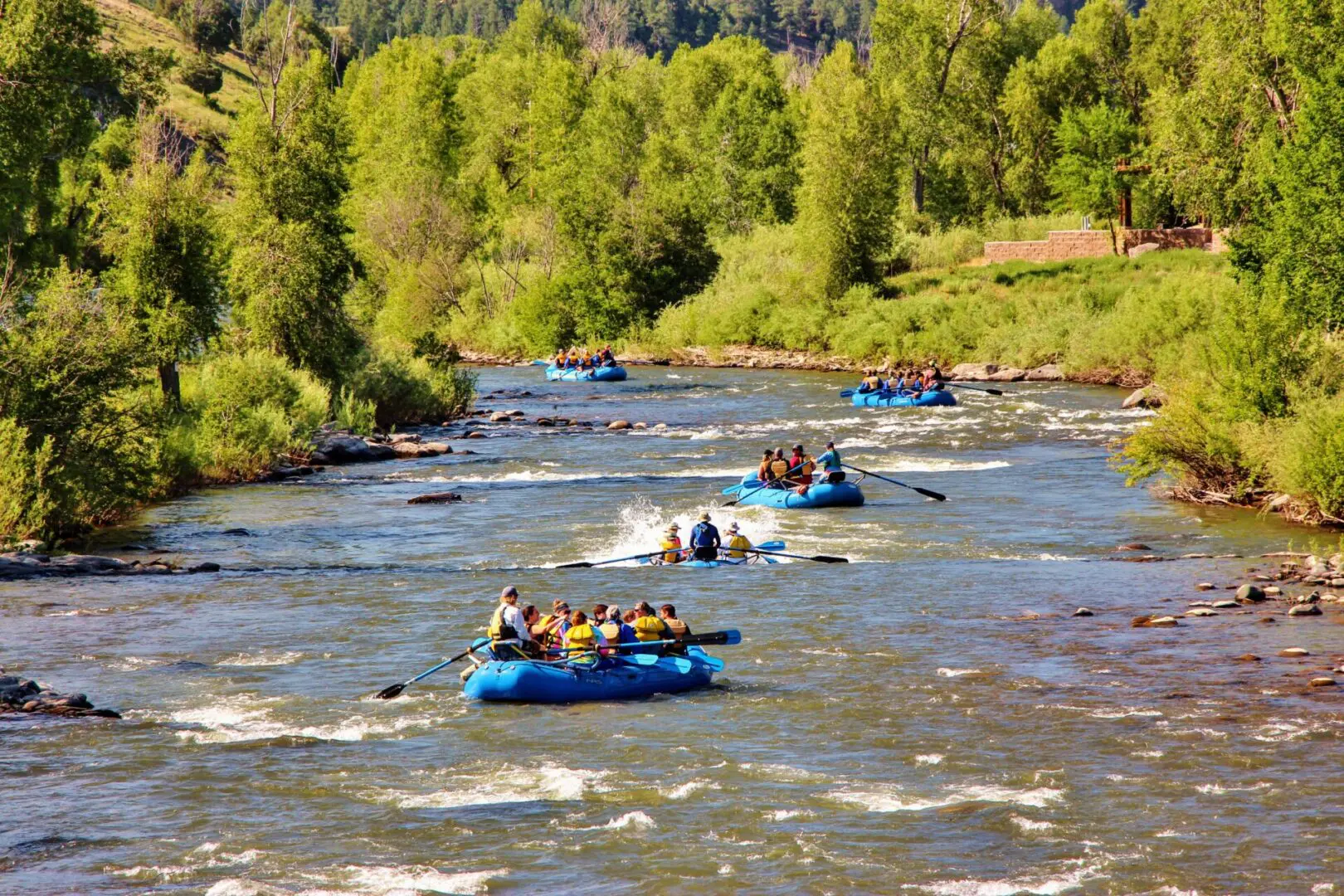 A group of people in rafts on the river.