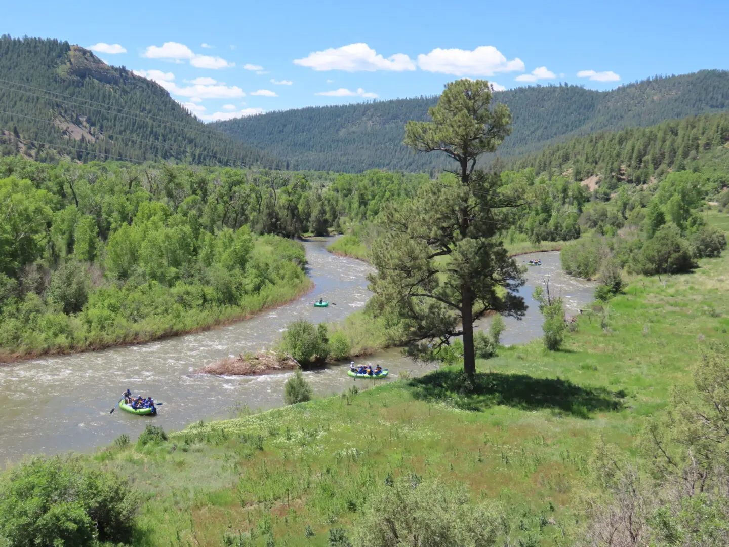 A river running through the middle of a green valley.